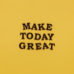 Simple and motivational quote 'Make Today Great' on a minimalist yellow background for inspiration.